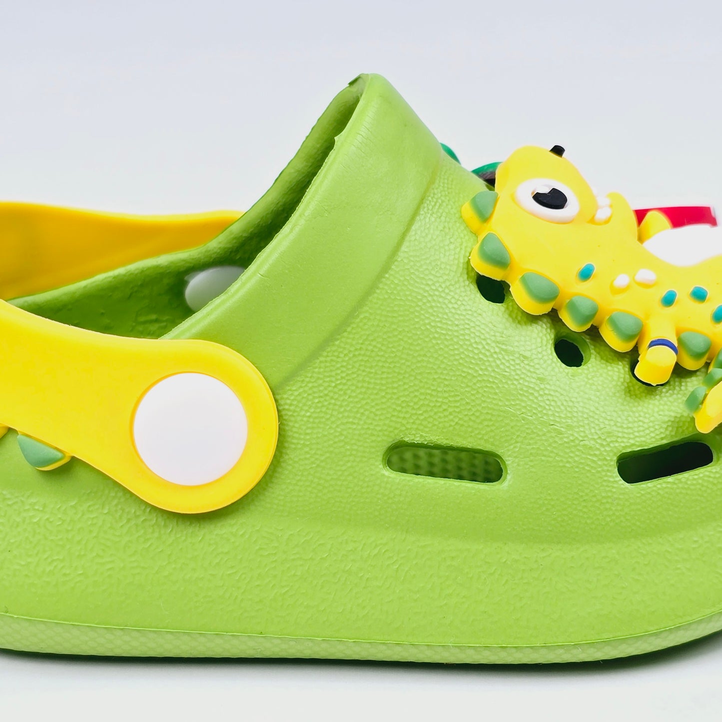 Parrot ,White, Pink,Yellow and Blue crocs with dinosaur pattern