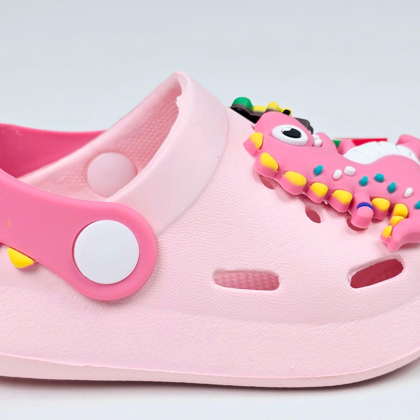 Parrot ,White, Pink,Yellow and Blue crocs with dinosaur pattern