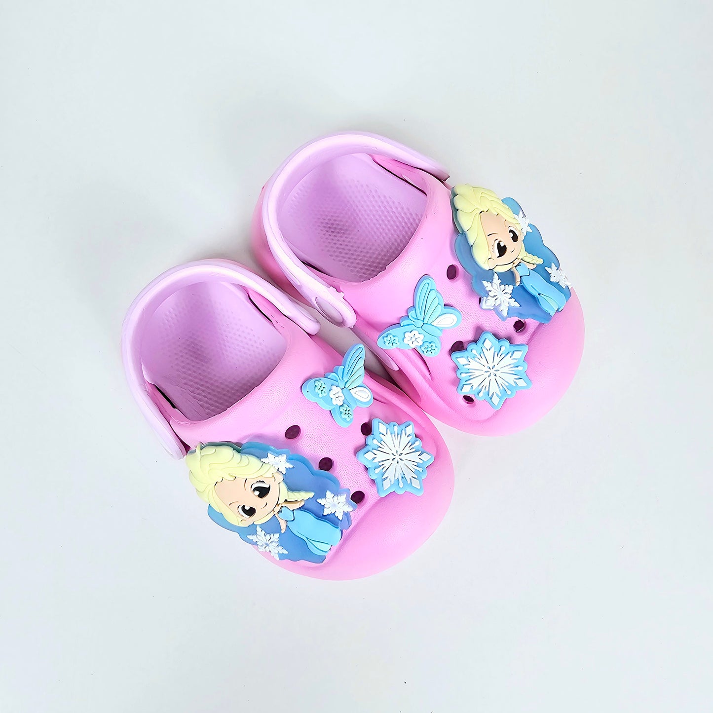 lavender, pink and peach crocs with cartoon and butterfly pattern