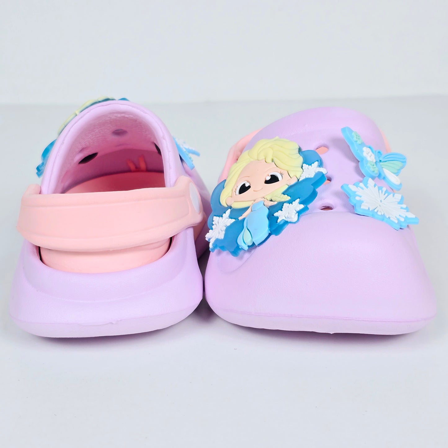 lavender, pink and peach crocs with cartoon and butterfly pattern