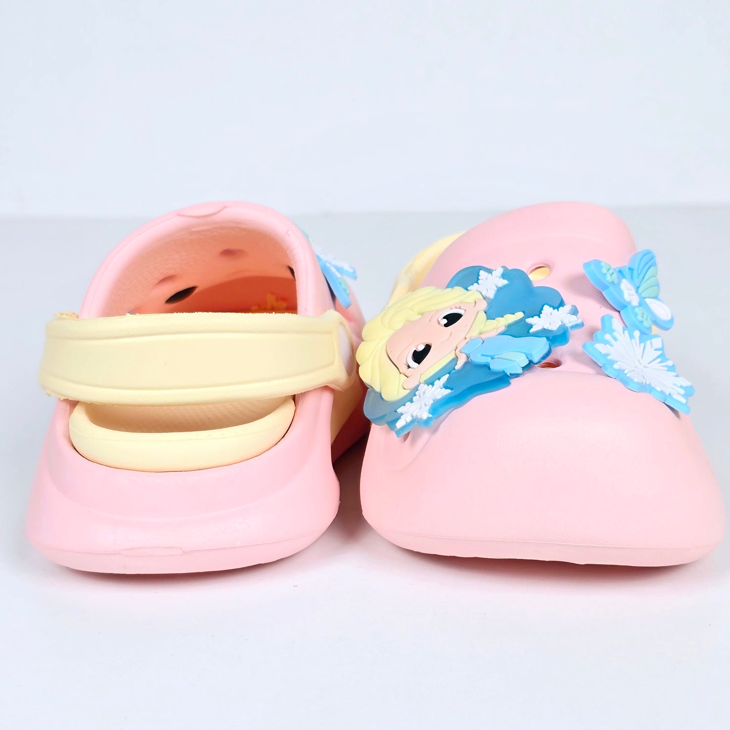 lavender, pink and peach crocs with cartoon and butterfly pattern